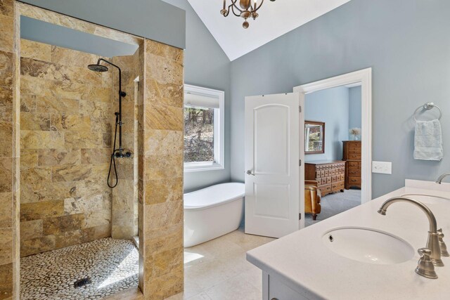 full bath featuring lofted ceiling, double vanity, a tile shower, and a freestanding bath
