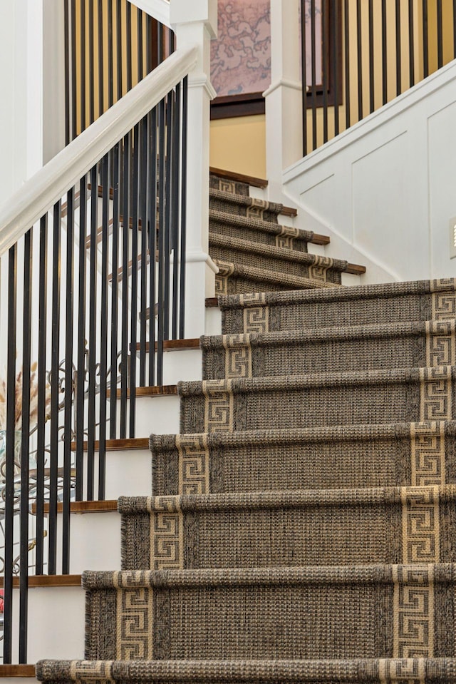 stairway with wallpapered walls