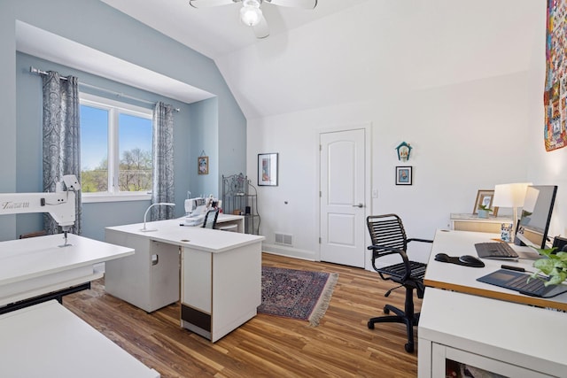 office area featuring vaulted ceiling, ceiling fan, and wood finished floors