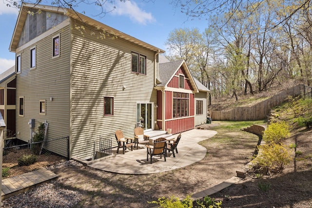 rear view of house with a fenced backyard and a patio area