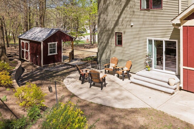 view of patio with a shed, an outdoor structure, and fence
