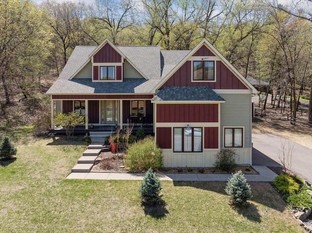 1067 Pioneer Rd, Red Wing, MN 55066 - view of front of home with roof with shingles, a front lawn, covered porch, and board and batten siding