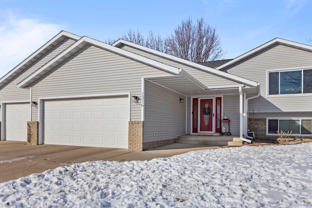 view of front of home featuring brick siding and an attached garage