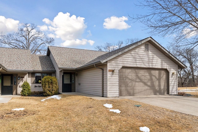 ranch-style house featuring driveway, an attached garage, and a shingled roof