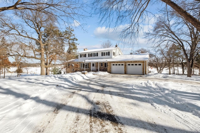 view of front of home with a garage, driveway, and a chimney