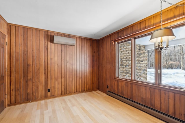 spare room featuring a wall unit AC, wood walls, baseboard heating, and wood finished floors