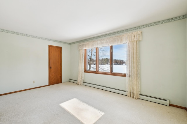 unfurnished room featuring carpet floors, baseboards, and a baseboard heating unit