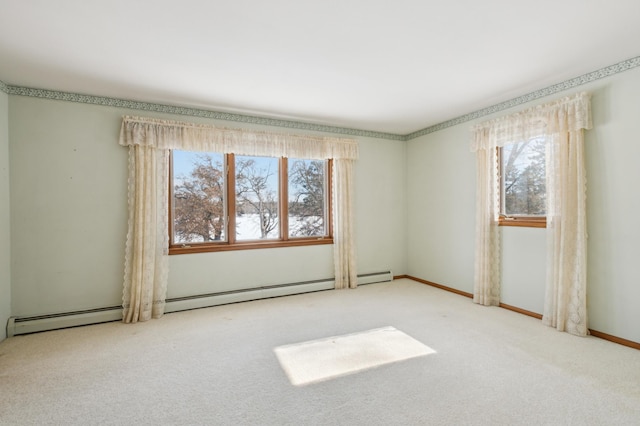 spare room with baseboard heating, carpet flooring, and baseboards