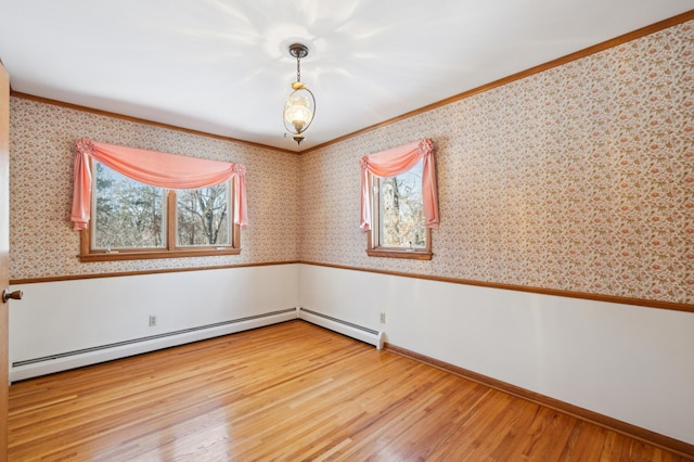 spare room with wallpapered walls, wainscoting, a baseboard radiator, ornamental molding, and wood finished floors