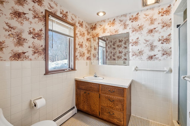 full bathroom with wallpapered walls, a baseboard radiator, a tile shower, and wainscoting