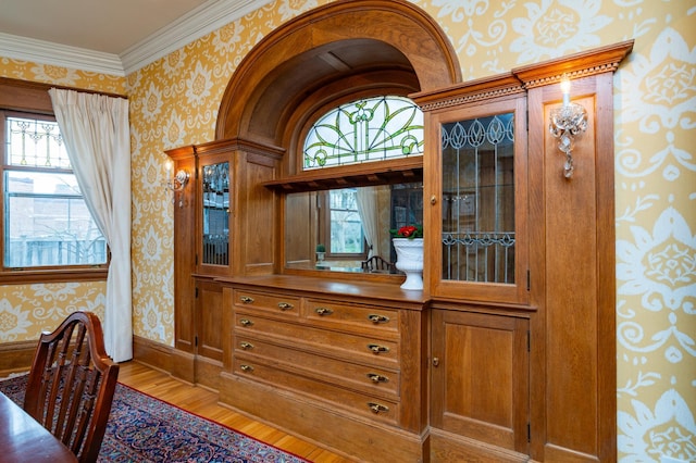 interior details featuring wallpapered walls, baseboards, and wood finished floors