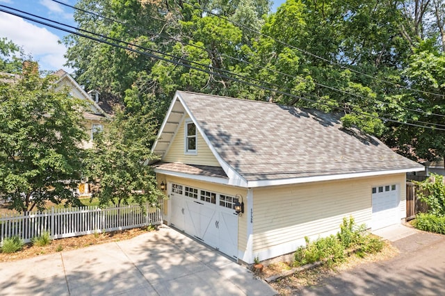 detached garage featuring fence