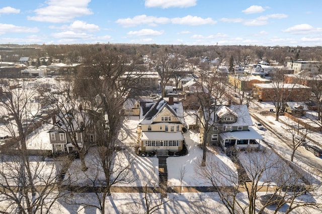 snowy aerial view with a residential view