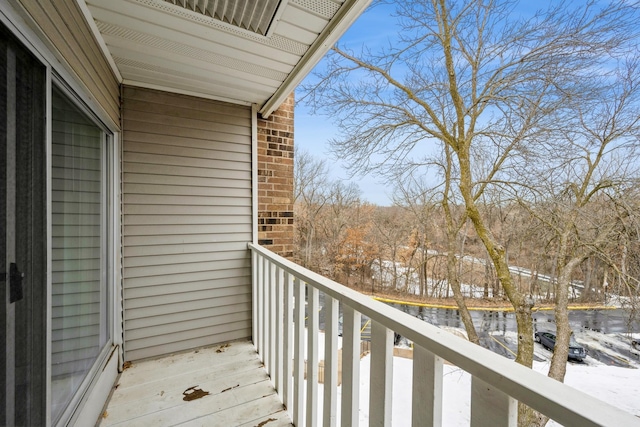 view of snow covered back of property