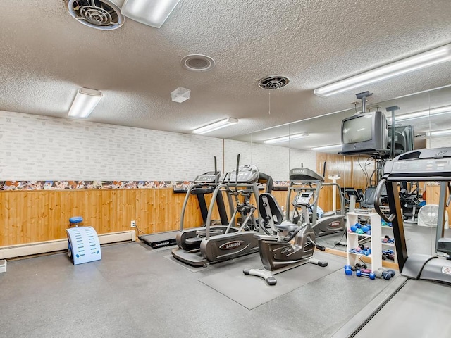 gym featuring visible vents and a textured ceiling