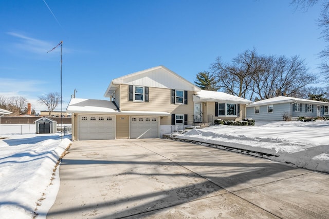 tri-level home with a garage, driveway, a storage unit, and an outdoor structure