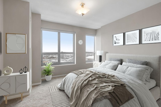 bedroom featuring light carpet and baseboards