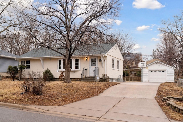 ranch-style home with an outdoor structure, a detached garage, and driveway