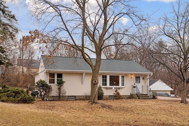 ranch-style home featuring a shingled roof and a chimney