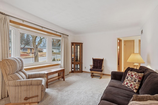 living area with carpet flooring, visible vents, and baseboards