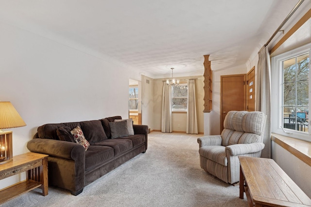 living area featuring a notable chandelier and light colored carpet