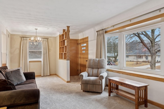 living room featuring a wealth of natural light, a chandelier, and light carpet