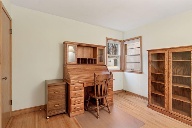 office area featuring baseboards and light wood-type flooring