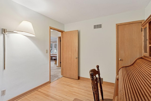 unfurnished dining area featuring visible vents, baseboards, and light wood-style floors