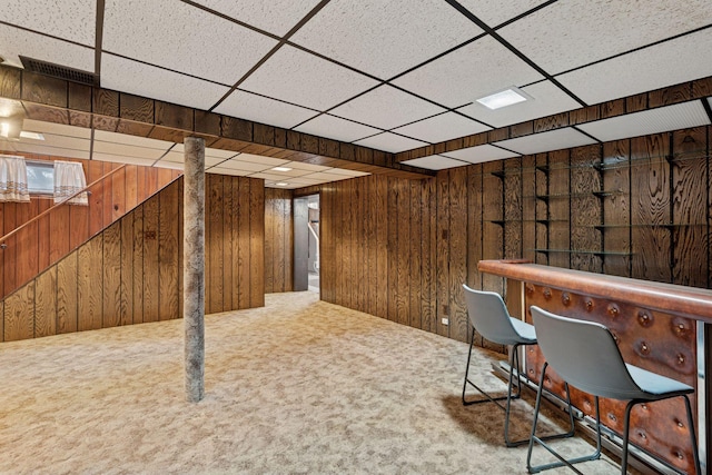 unfurnished office featuring wooden walls, a dry bar, and carpet