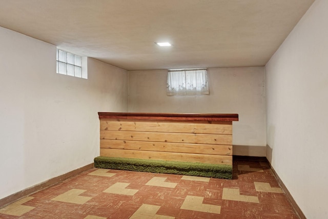 bar with tile patterned floors, plenty of natural light, and baseboards