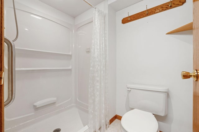 full bathroom with baseboards, toilet, and a shower stall