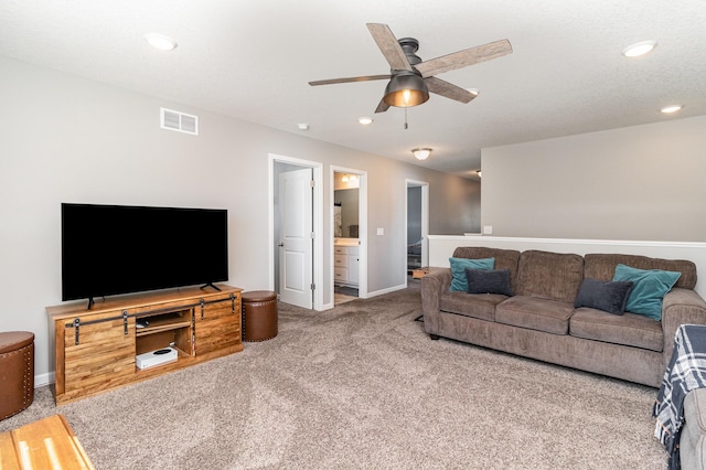 carpeted living room featuring baseboards, ceiling fan, recessed lighting, and visible vents