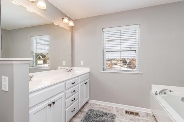 full bathroom with double vanity, baseboards, visible vents, and a sink