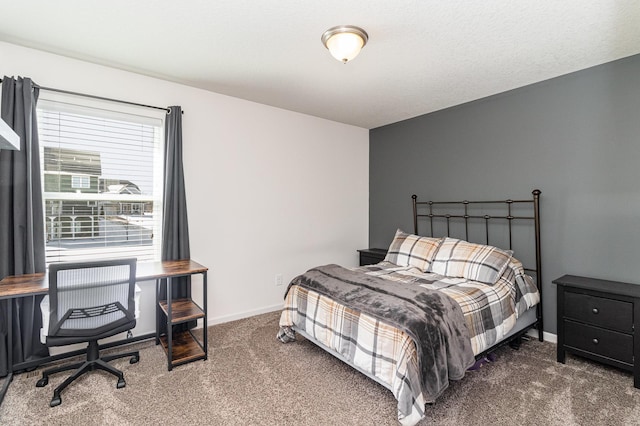 carpeted bedroom featuring baseboards