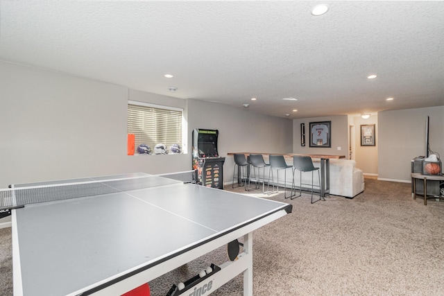 playroom featuring recessed lighting, a textured ceiling, carpet floors, and a bar