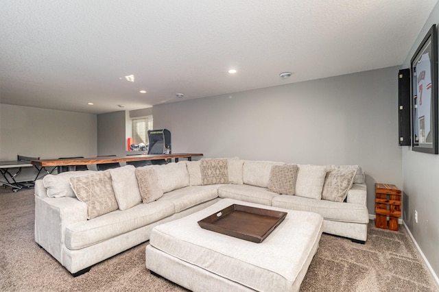 carpeted living area with recessed lighting and baseboards