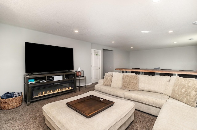 carpeted living area featuring a glass covered fireplace and recessed lighting