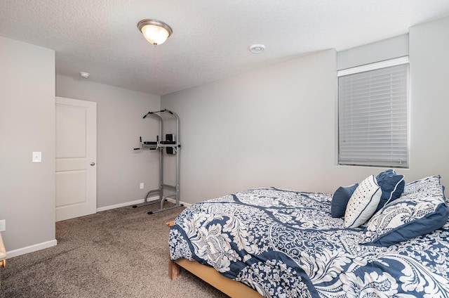 carpeted bedroom with baseboards and a textured ceiling