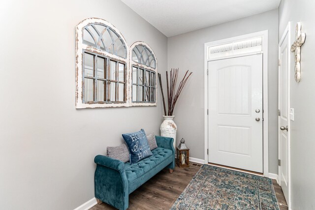 entrance foyer featuring baseboards, wood finished floors, and visible vents