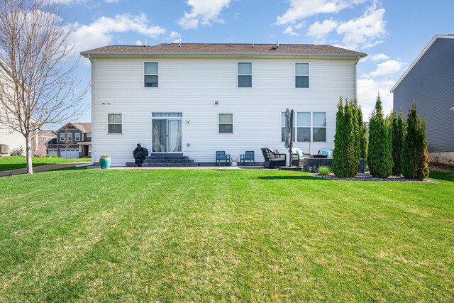 rear view of house featuring a patio and a yard