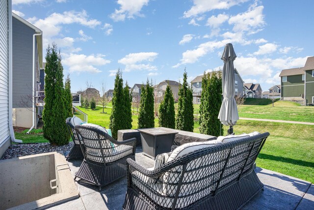 view of patio featuring a residential view and an outdoor living space with a fire pit