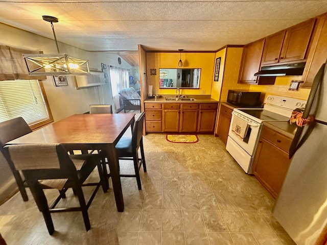 kitchen featuring brown cabinetry, under cabinet range hood, hanging light fixtures, and electric range