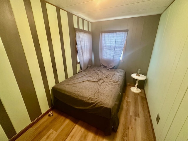 bedroom featuring light wood-style floors and baseboards