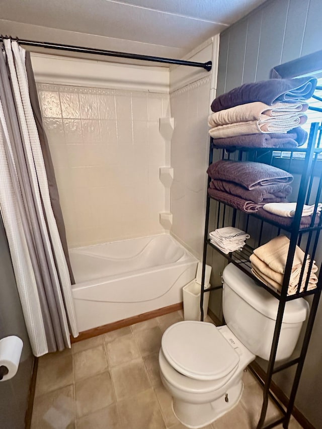 full bath featuring tile patterned flooring, shower / bathtub combination with curtain, and toilet