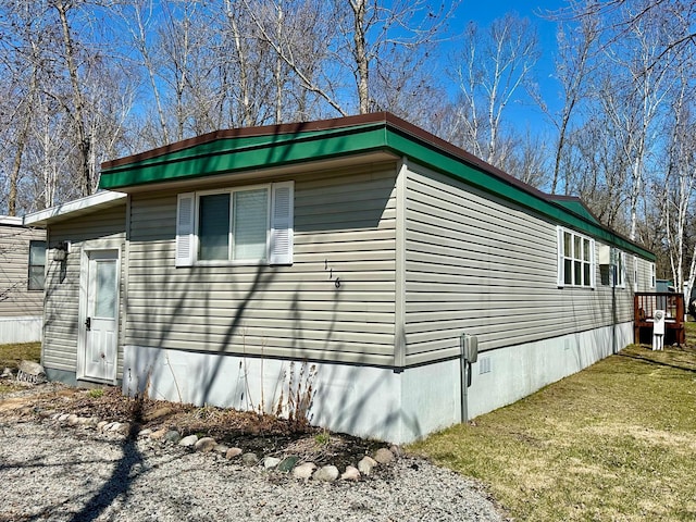 view of property exterior with a lawn