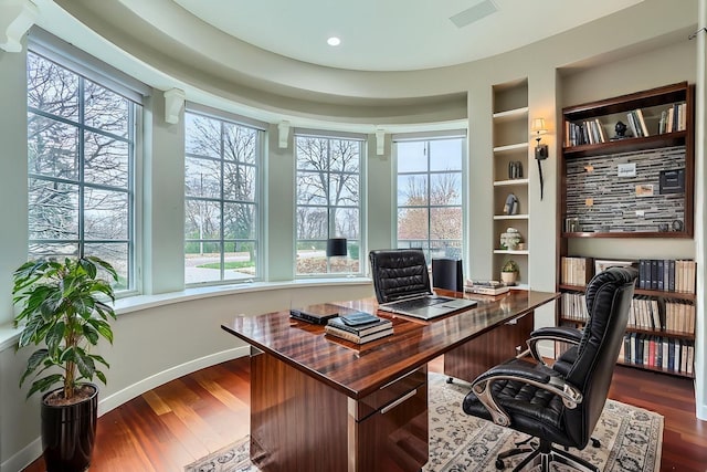 home office featuring recessed lighting, visible vents, baseboards, built in features, and dark wood finished floors