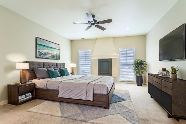 bedroom with light carpet, recessed lighting, a ceiling fan, and baseboards