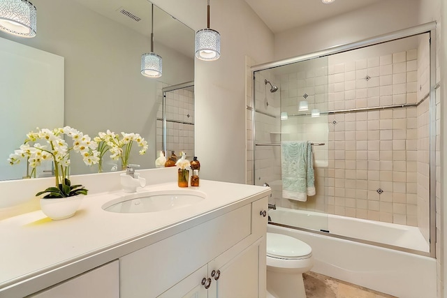 full bath with toilet, visible vents, combined bath / shower with glass door, and vanity