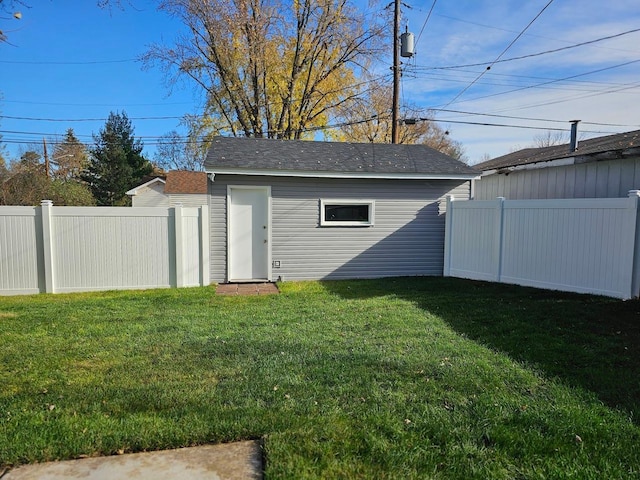 view of outbuilding with a fenced backyard and an outbuilding