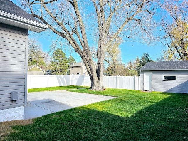 view of yard with an outbuilding, a patio area, and a fenced backyard